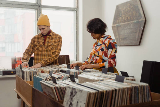 man and woman looking at vinyl records