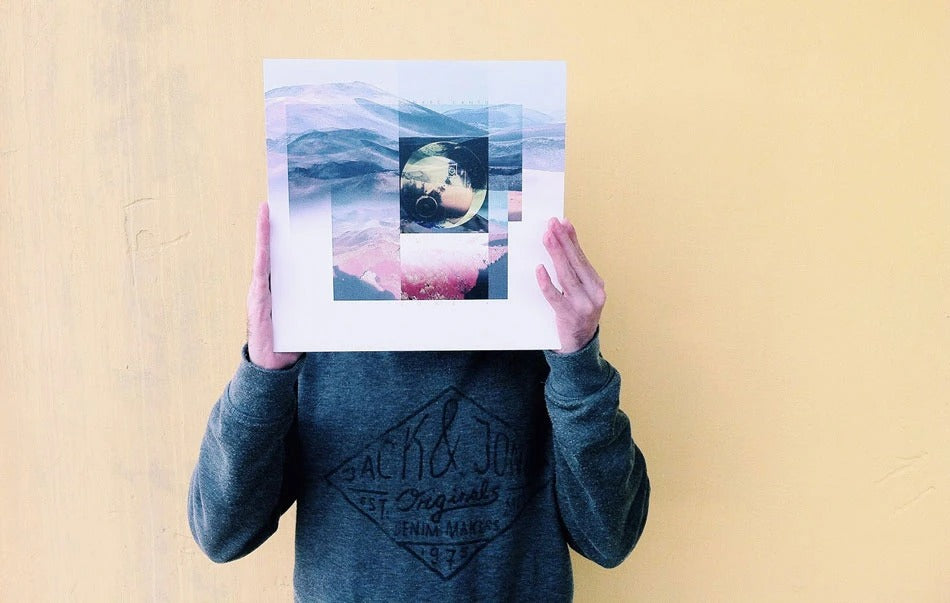 Person holding a modern vinyl record in front of their face