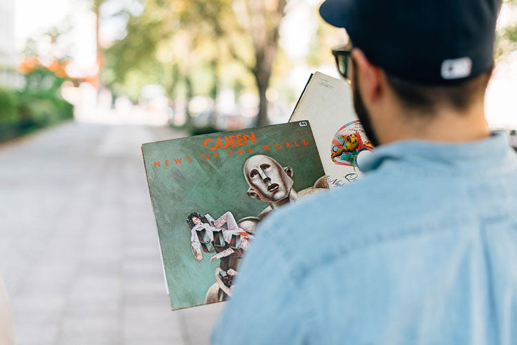 Music memorabilia collector holding Queen’s News of the World