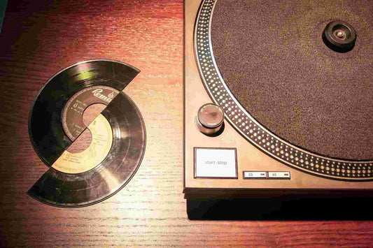 broken and scratched record beside a turntable