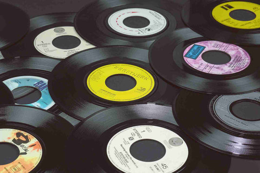 scattered stack of vinyl records