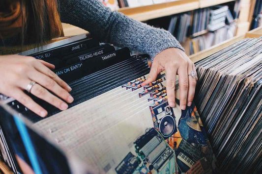 A child lying down surrounded by vintage vinyl records and a record player File name vintage-vinyl-records