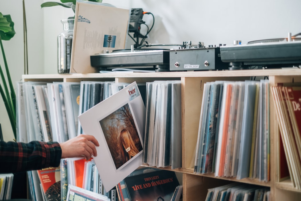 Pulling a vinyl record off the shelf to clean it