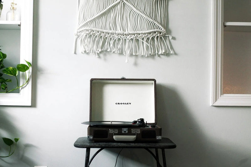 Crosley record player against white with macrame decor