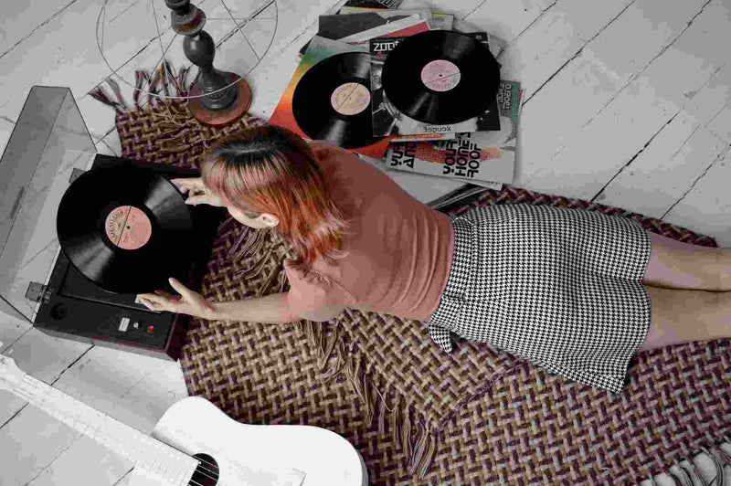 woman getting ready to play vinyl records in her room
