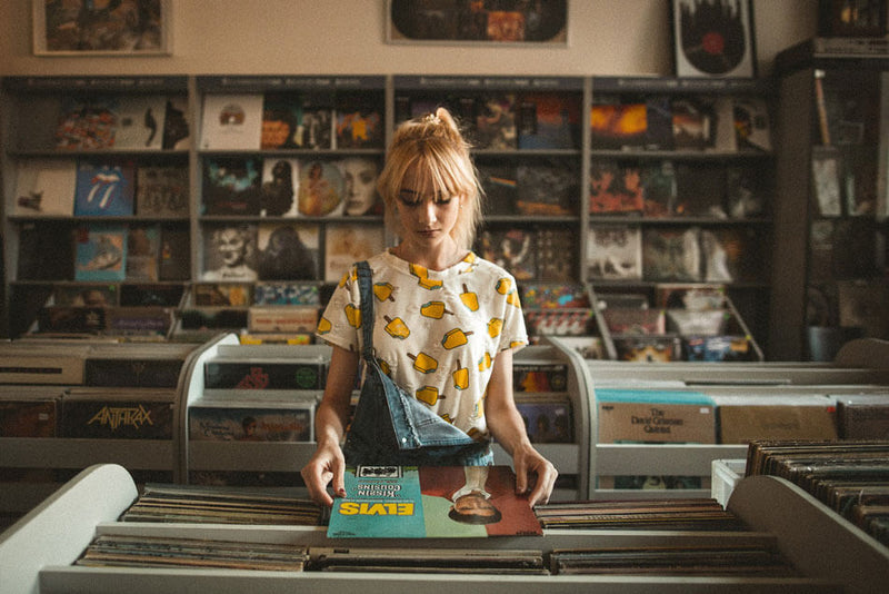 Young girl browsing vinyl record albums