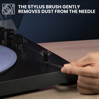 Person using a stylus brush on a turntable with text indicating its use.