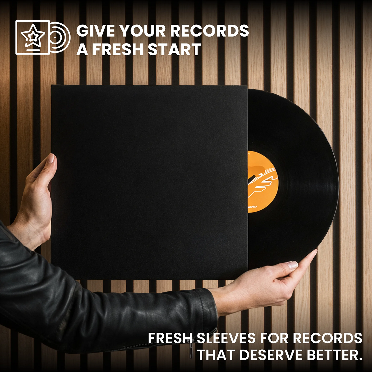A person in a black leather jacket holds a vinyl record partially slid out of a black sleeve against a vertical wood slat background. White promotional text reads 'GIVE YOUR RECORDS A FRESH START' at the top and 'FRESH SLEEVES FOR RECORDS THAT DESERVE BETTER. _Matte Black