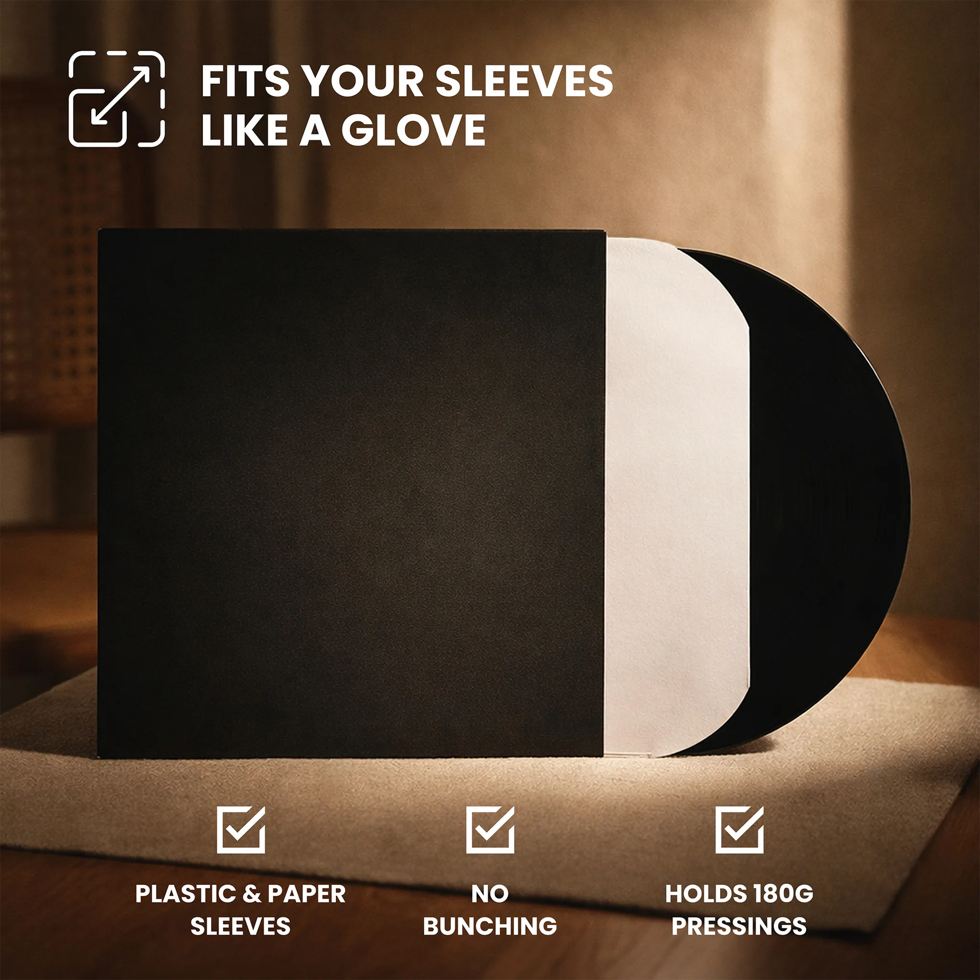 Black vinyl record sleeve with a white inner sleeve partially pulled out, shown on a wooden surface with text reading 'FITS YOUR SLEEVES LIKE A GLOVE' and feature callouts below.  _Matte Black