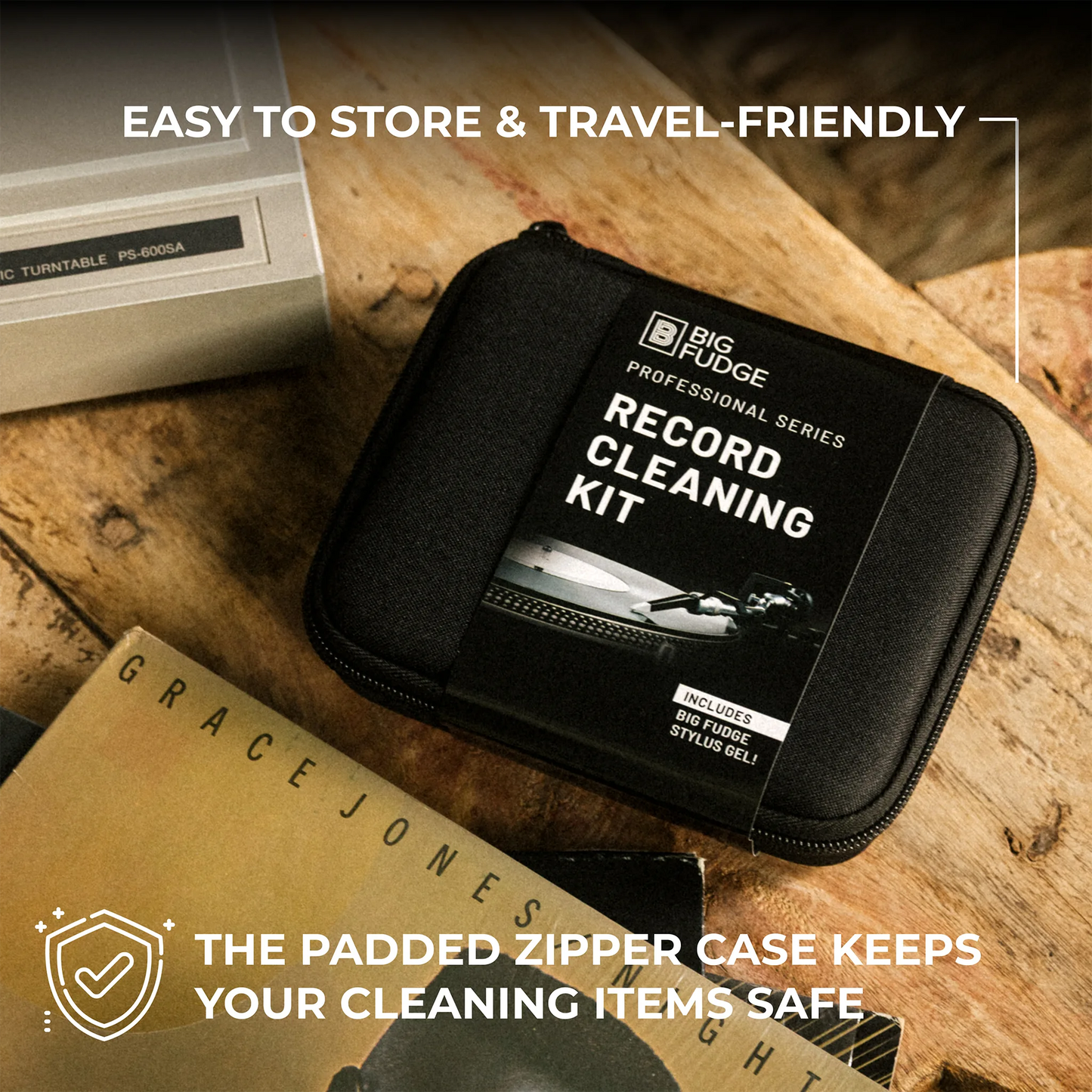 A black zippered record cleaning kit case labeled 'BIG FUDGE PROFESSIONAL SERIES RECORD CLEANING KIT' placed on a rustic wooden surface, with promotional text overlays around it.