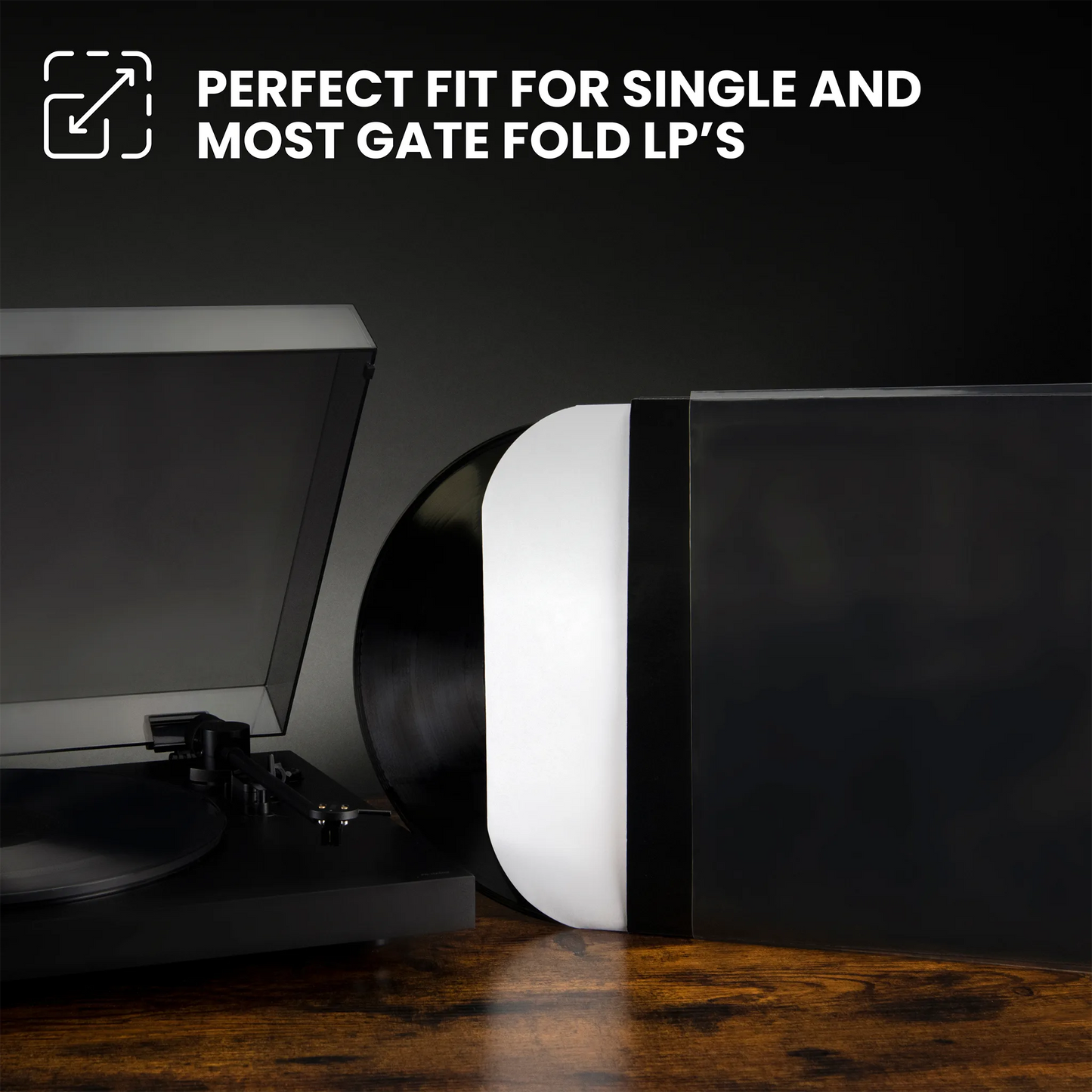 A black vinyl record partially inserted into a record player, with a large black rectangular object beside it on a wooden surface. White text at the top reads 'PERFECT FIT FOR SINGLE AND MOST GATE FOLD LP'S' with a small icon.  _10 inch  _12 inch