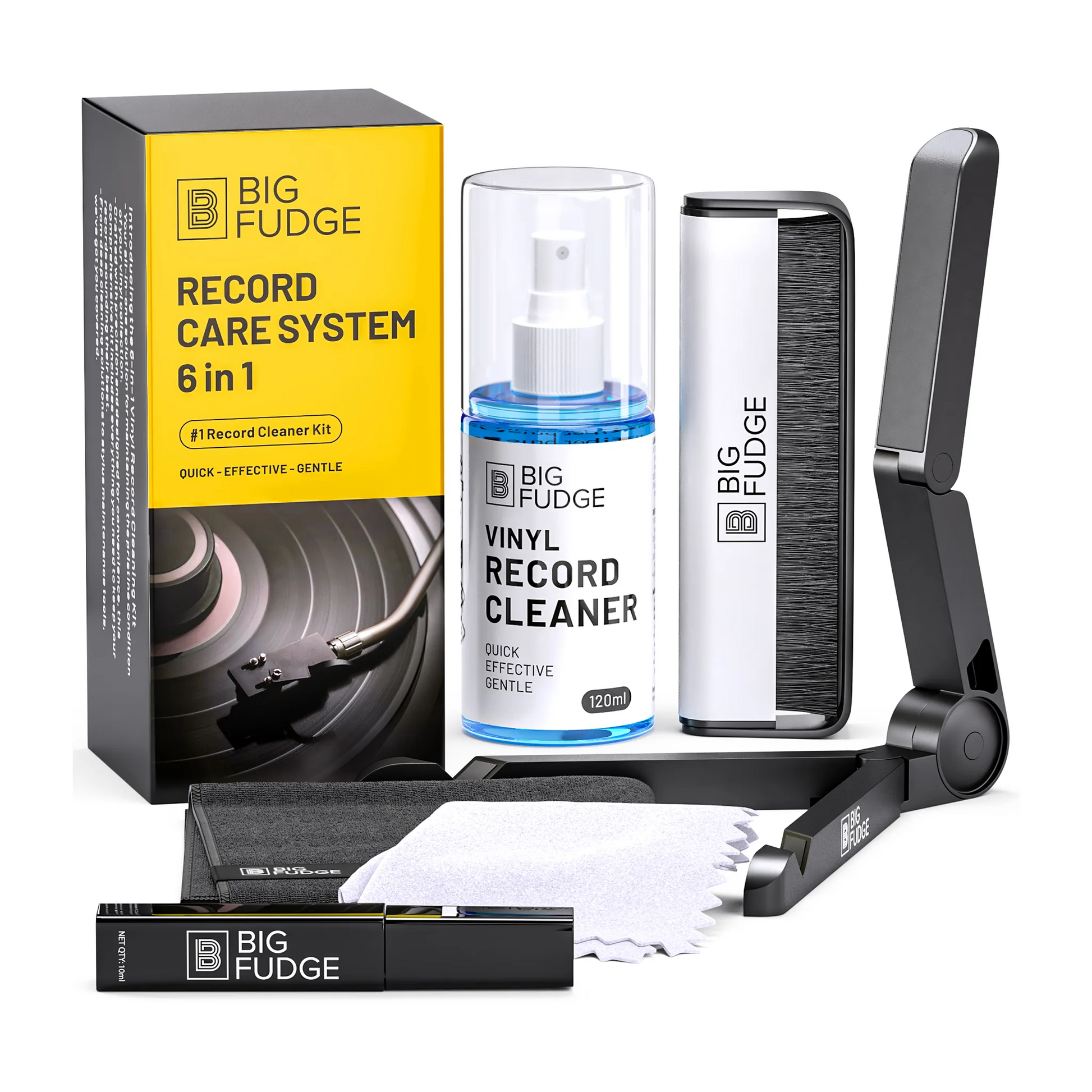 Big Fudge Record Care Kit 6 in 1 shown with its yellow and black retail box, a bottle of vinyl record cleaner, a white and black brush, a black folding stand, a black spray canister, a white cloth, and a small black tube on a clean white background.