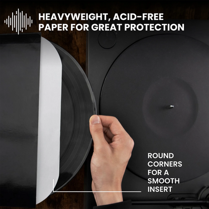 A hand inserts a black vinyl record into a turntable with white text overlays reading 'HEAVYWEIGHT, ACID-FREE PAPER FOR GREAT PROTECTION' and 'ROUND CORNERS FOR A SMOOTH INSERT'. _12 inch