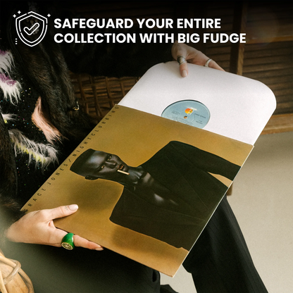 A person holds a vinyl record sleeve featuring a black-and-white portrait of a figure on a gold background, with a white record partially visible. The scene is indoors, and promotional text at the top reads, 'SAFEGUARD YOUR ENTIRE COLLECTION WITH BIG FUDGE. _12 inch