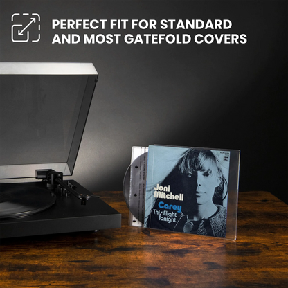 A CD jewel case for Joel Mitchell's 'Carey - Thy Flight tonight' sits on a wooden table next to a turntable, with promotional text at the top reading 'PERFECT FIT FOR STANDARD AND MOST GATEFOLD COVERS'. _7 inch