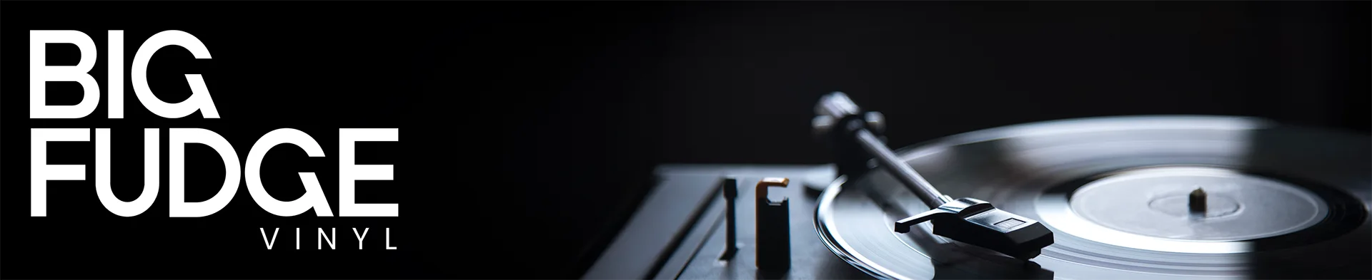 Promotional graphic for Big Fudge Vinyl featuring bold white text on a black background alongside a dimly lit turntable with a vinyl record partially visible.