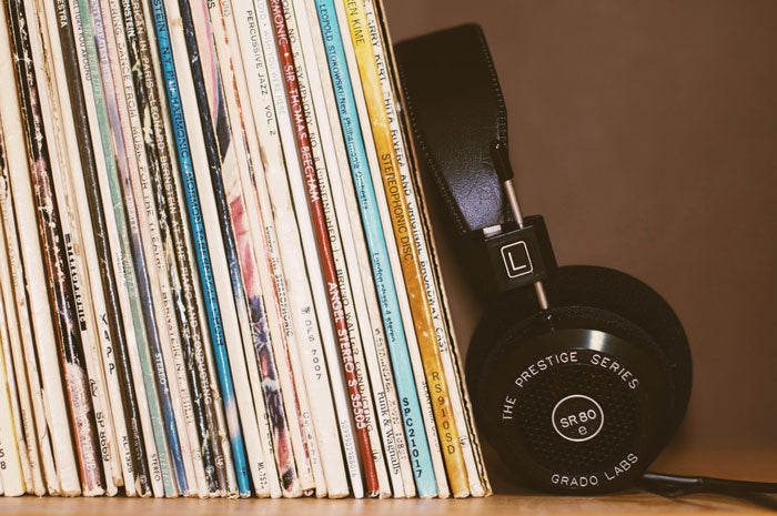 vinyl records on a bookshelf with headphones